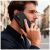 Férfi használja a fekete-piros Tech-Protect Wallet tokot Samsung Galaxy A57 5G-hez