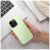 Kézben tartott Roar Cloud Skin világoszöld szilikon tok iPhone 17 Pro-n laptop mellett, bemutatva a mindennapi használatot és az ergonómikus kialakítást.