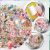 Virágos matricák 58 db Színes DIY Scrapbooking dekorációk - részletes nézet az egyedi virágos és vintage matricákról, bemutatva átlátszó hátterüket és bonyolult mintáikat, közelképpel a matrica felhelyezésről
