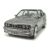 Közelről készült elölnézet egy Norev 1:43 méretarányú szürke 1986-os BMW E30 M3 modellautóról, kiemelve a hűtőrácsot és a fényszórókat