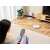 Woman controlling Dreame D10 Plus robot vacuum cleaner with a smartphone