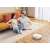 Couple relaxing on a sofa while Dreame D10 Plus robot vacuum cleaner cleans the floor