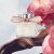 Chloé L'Eau de Parfum Lumineuse 5 ml mini parfümös üveg természetes környezetben, rózsaszín virágokkal