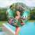 Girl holding Bestway Floral Fantasy 114 cm inflatable swim ring with zebra and flamingo print