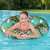 Girl using Bestway Floral Fantasy 114 cm inflatable swim ring with zebra and flamingo print