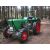 Zöld Deutz traktor piros kerekekkel erdei környezetben, bemutatva a spray festék potenciális felhasználását felújításhoz