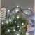 Emos D5AC06 80 LED cool white cherry ball string lights decorating a Christmas tree.