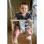 Baby enjoying the 3-in-1 gray swing with safety harness