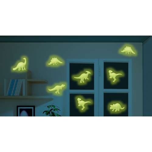 Glow-in-the-dark dinosaur wall stickers on a wall in a dark room