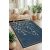 Conceptum Hypnose Carpet (50 x 80) Multicolor 147, sötétkék pamut szőnyeg fehér cseresznyevirág mintával modern nappaliban kanapéval és növényekkel