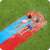 Two kids sliding down the Bestway H2OGO Tsunami Splash Ramp double lane water slide