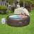 Couple relaxing in Lay-Z-Spa hot tub with canopy, spa sun shade in garden