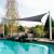 Gray Triangle Shade Sail installed by a pool