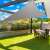 Grey triangular sun sail, 3.6x3.6x3.6m, providing shade for outdoor dining