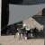 Grey triangular sun sail, 3.6x3.6x3.6m, providing shade for outdoor areas