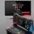 X7M portable game console with 500 built-in games, black and red color, showing TV output port and USB charging port