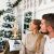 Couple admiring a decorated Christmas tree in a festive setting