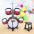 Red toy drum set with stool, Big Band brand, in a room with balloons