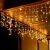 Springos warm white LED icicle lights on wooden eaves