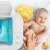 Neno Calor baby wipe warmer, baby being wiped with a warm wipe, yellow diaper