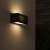 Avide Lima E27 outdoor wall light mounted on a wall, turned on