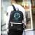 Kruzzel reflective backpack with USB and jack connector, black, worn by a person from the back