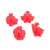 Set of 4 red plastic cookie cutters with spring-loaded plungers, featuring gingerbread man, snowflake, Santa Claus, and Christmas tree shapes