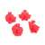Set of 4 red plastic cookie cutters with spring-loaded plungers, featuring gingerbread man, snowflake, Santa Claus, and Christmas tree shapes
