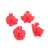 Set of 4 red plastic cookie cutters with spring-loaded plungers, featuring gingerbread man, snowflake, Santa Claus, and Christmas tree shapes