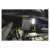 Emos rechargeable LED work light, green and black, in use under the hood of a car