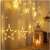 LED star curtain lights hanging on a wall, warm white, 138 LEDs