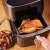 Tefal Easy Fry Grill & Steam air fryer cooking chicken and fries
