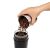 Pouring coffee beans into DeLonghi KG200 coffee grinder