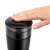 DeLonghi KG-200 coffee grinder, black, top view, hand pressing the lid