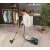 Woman vacuuming a rug with Hoover HP330ALG bagless vacuum cleaner