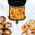 Tesla AirCook Q70 XXL air fryer with fries, bacon wrapped meat, and shrimp