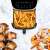 Tesla AirCook Q70 XXL Air Fryer with French fries, bacon-wrapped dates and shrimp