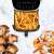 Tesla AirCook Q70 XXL Air Fryer with French fries, bacon-wrapped dates and shrimp