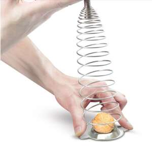 Hand using a stainless steel nutcracker to crack a walnut - Nutcracker