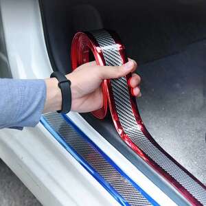 Person installing gold carbon fiber car door edge guard trim on a white car - Nonbrand Vehicle wrap