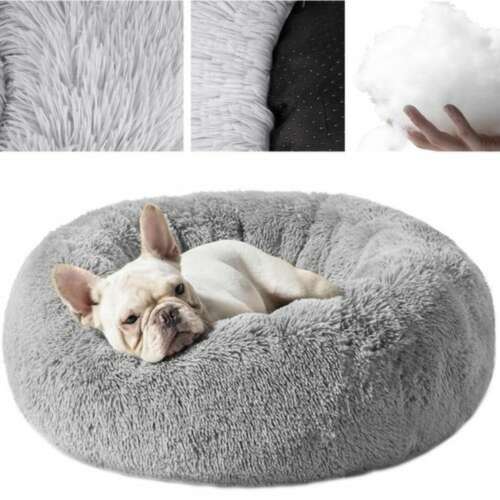 Grey plush dog bed with a dog sleeping in it, showing the soft fur and the raised edges