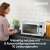 Woman using Severin MW7751 microwave oven in kitchen