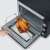 Severin TO2073 Mini Oven, black, open door, chicken on rotisserie