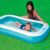 Child playing in Intex 166x100x28 cm inflatable pool, summer fun