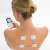 Woman using Beurer EM49 TENS EMS device on her back
