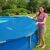 Woman placing Intex Solar Pool Cover on Pool
