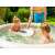 Intex PureSpa jacuzzi seat, beige, being placed in inflatable hot tub