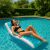 Woman relaxing on Intex inflatable pool lounge in swimming pool