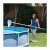 Woman using Intex telescopic aluminum pool pole to clean her pool