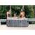 Four people relaxing in the Intex PureSpa Greywood Deluxe inflatable hot tub